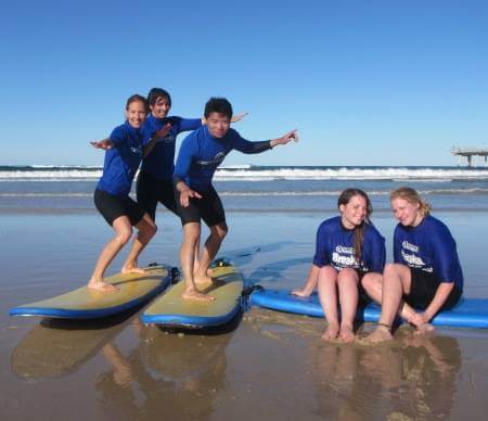 English school students Learning to Surf